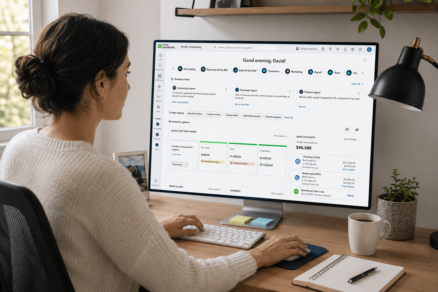 A bookkeeper working in QuickBooks Online at her home-office desk
